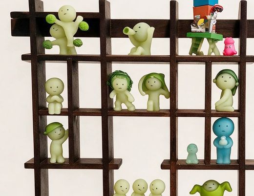 Figures sitting on the rails of the Peeko Shelf