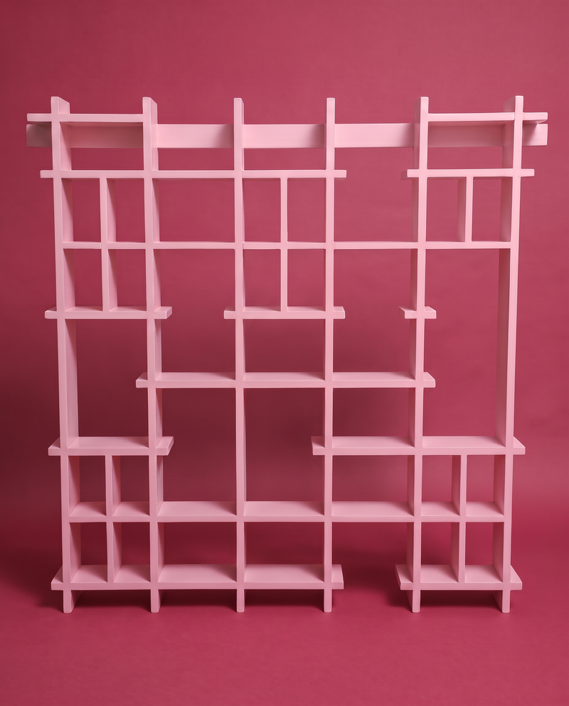 Figures sitting on the rails of the pink Peeko Shelf