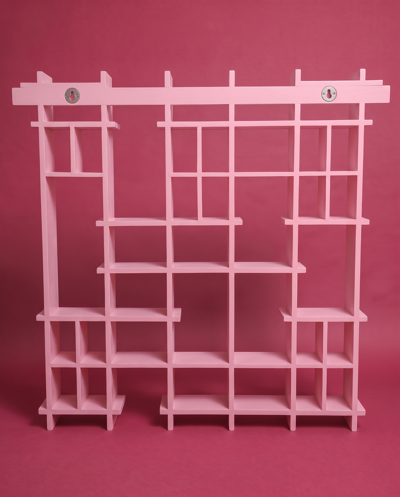The pink Peeko Shelf on a wall