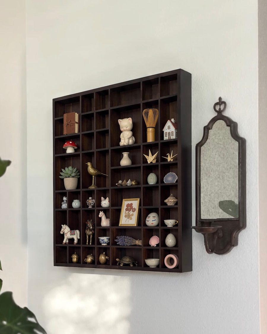 The shelf filled with small figures and keepsakes